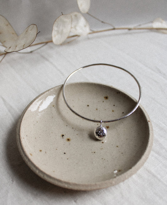 recycled silver bangle round with a stamped celestial pebble 